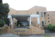 Man charged after body found on beach