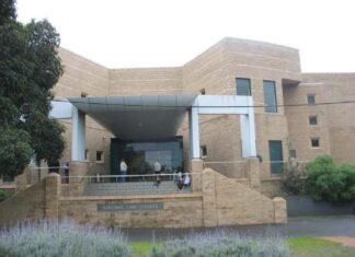 Man charged after body found on beach